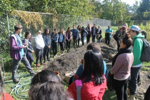 Doug Anderson teaches teacher candidates about the Indigenous agricultural earth mound