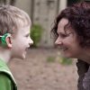 Son with hearing aid and mother