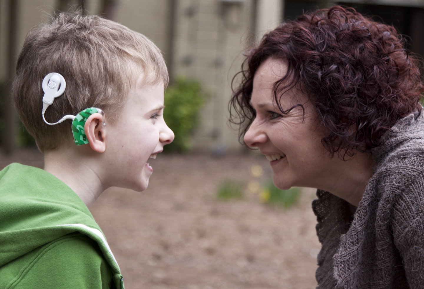 Son with hearing aid and mother