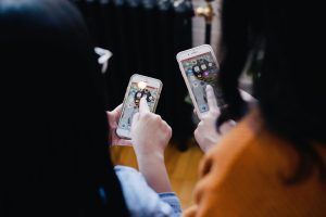 Two people using smarphones