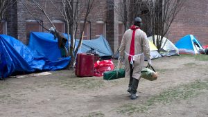 Someone walking nearby tents